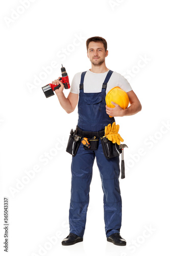 Εκτύπωση καμβά caucasian repairman worker in uniform holding yellow hard hat and cordless screwdriver