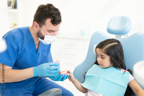 Dentist Discussing With Patient At Clinic