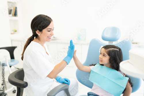 Smiling Dentist And Patient High-Fiving