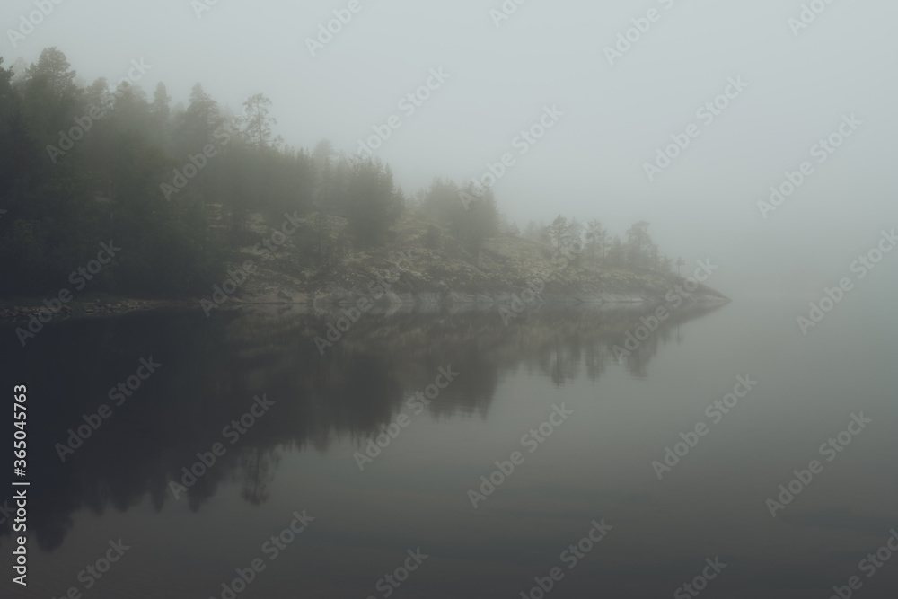 Fog over the lake. Early morning on Ladoga lake in Karelia, Russia. 