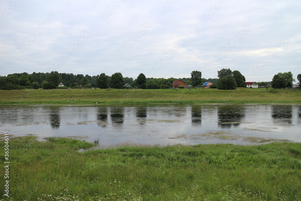 Cloudy day with clouds on the river in the countryside Cloudy day with clouds on the river in the countryside
