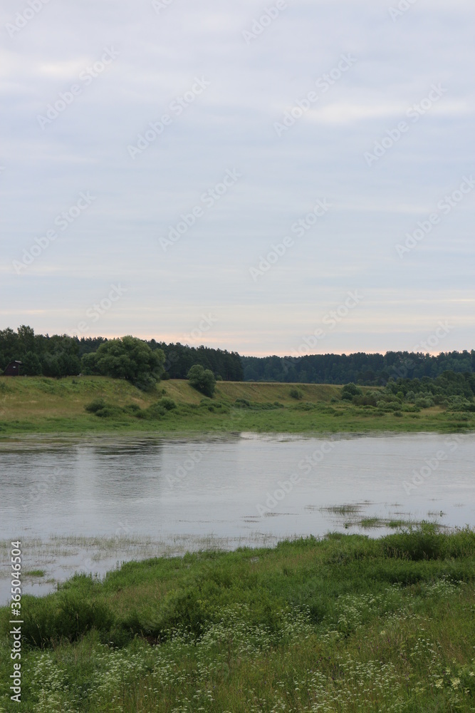 Cloudy day with clouds on the river in the countryside