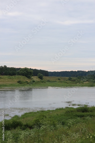 Cloudy day with clouds on the river in the countryside © Andrey