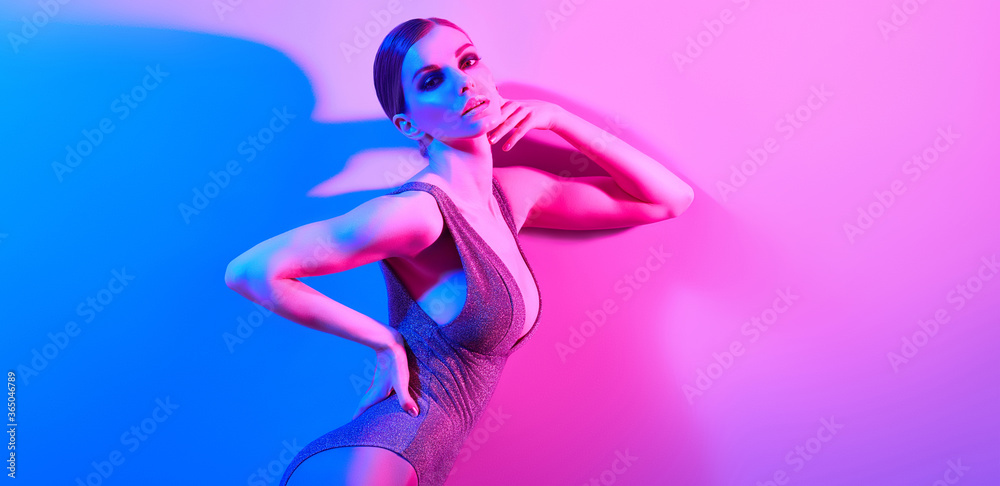 High Fashion. Woman in colorful neon light, make-up. Sexy girl, stylish hair, trendy bodysuit, makeup. Party disco neon style. Creative art beauty concept, fashionable fitness model, bright color High Fashion. Woman in colorful neon light, make-up. Sexy girl, stylish hair, trendy bodysuit, makeup. Party disco neon style. Creative art beauty concept, fashionable fitness model, bright color
