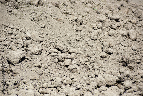 Dry ground with clods is close, soft focus