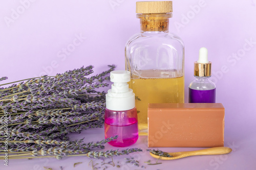 Lavender Soap, Lavande oil, lavander hydrolyte and bouquet on violet background, Homemade cosmetics, Beauty Concept photo