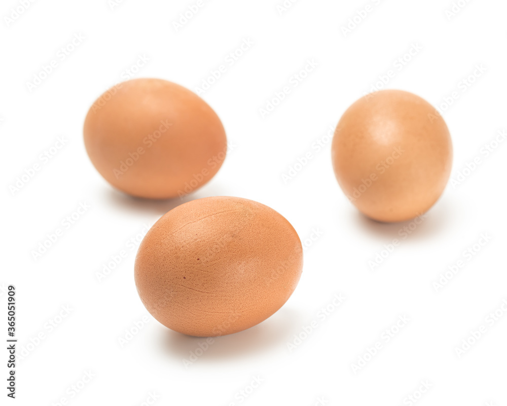 Three brown chicken eggs on a white background Three brown chicken eggs on a white background