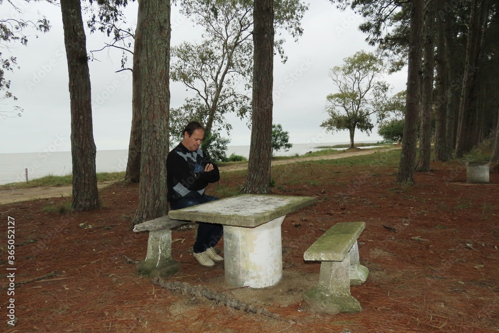 man sitting on bench in park man sitting on bench in park