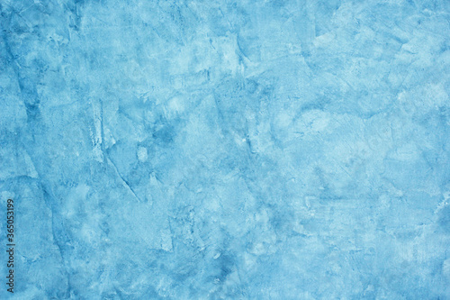 The background texture of the cement plaster is raw blue.
