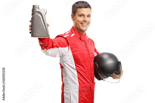 Car racer holding a helmet and a bottle of motor oil
