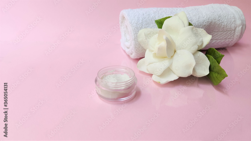 Spa setting and Spa background composition with white gardenia flower on pink background. Banner Spa setting and Spa background composition with white gardenia flower on pink background. Banner