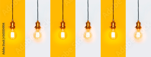 Creative idea concept, designer lamp, modern interior item. Vintage fashionable edison lamp on gray and yellow background. Top view flat lay. Lighting, electricity, pattern with lamp bulb
