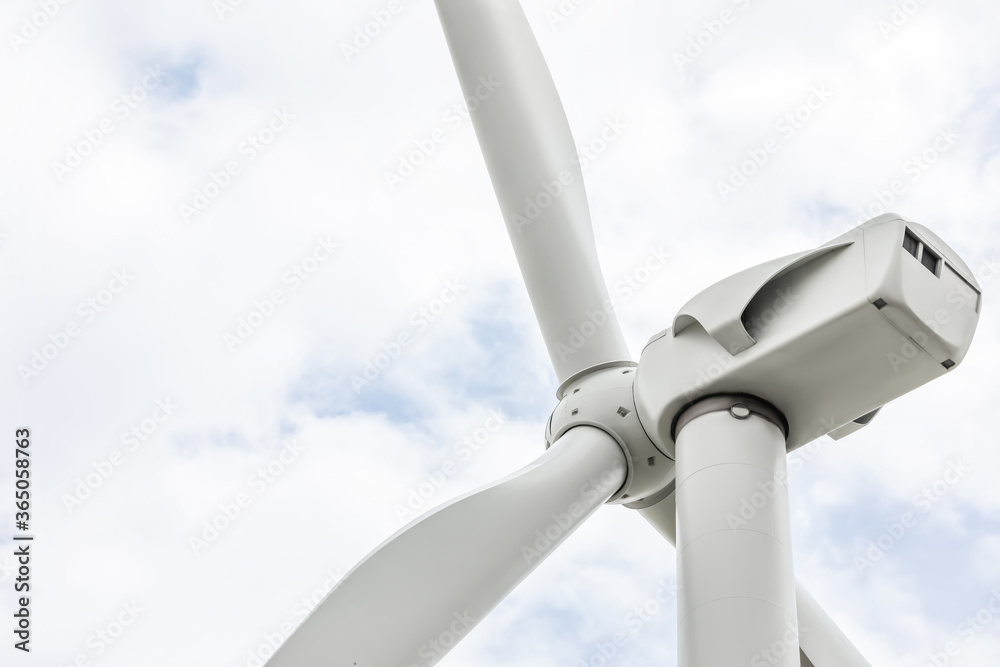Modern wind turbine against cloudy sky, closeup. Alternative energy source Modern wind turbine against cloudy sky, closeup. Alternative energy source