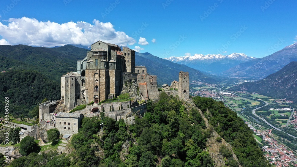The Sacra di San Michele (Saint Michael's) Abbey, Turin, Italy, shot aerial with mountains of Susa valley in background. Aerial view
