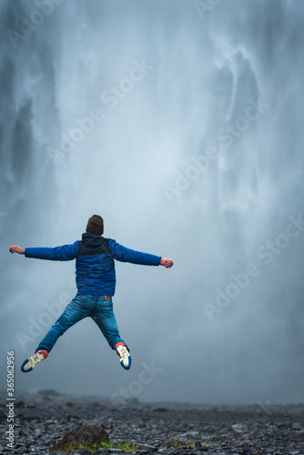Man jumping in front of Skogafoss Waterfall - Iceland