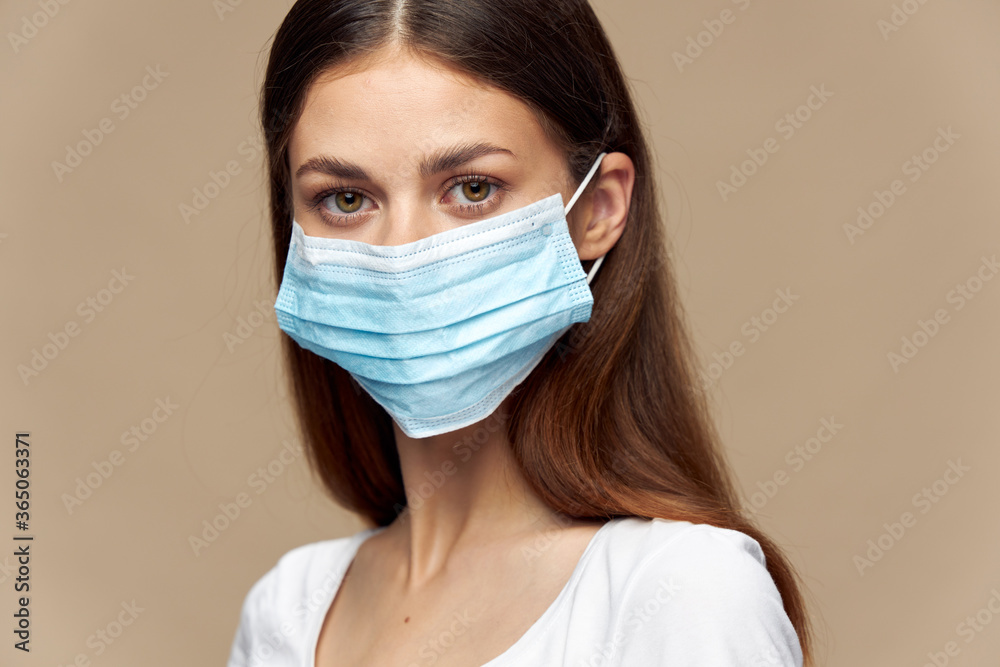 Beautiful girl in white shirt in a protective mask health insurance Beautiful girl in white shirt in a protective mask health insurance