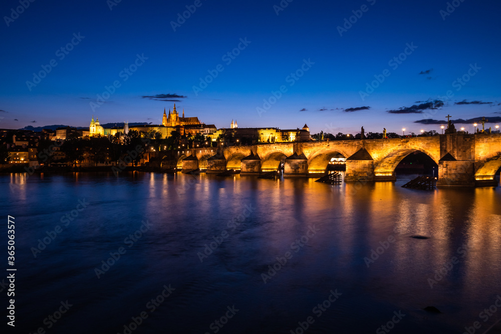 Charles Bridge in Prague at Night across River Vltava with Saint Vitus Cathedral and Prague Castle