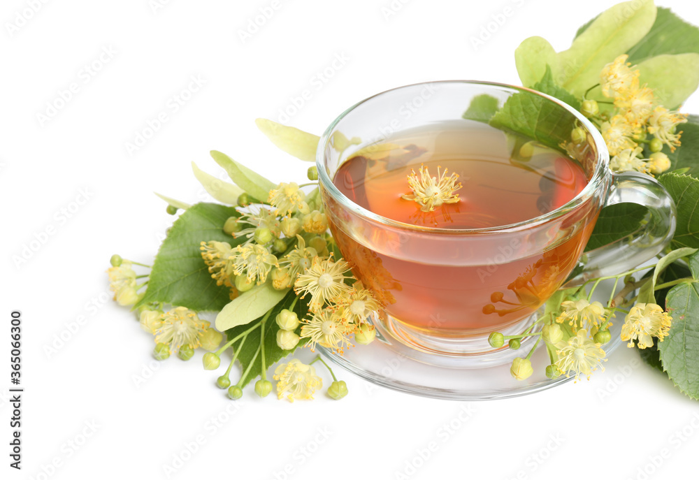 Cup of tea, linden leaves and blossom on white background Cup of tea, linden leaves and blossom on white background