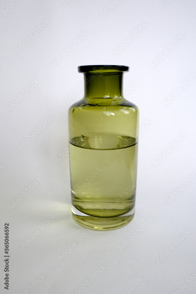 green vase bottle with liquid on a white background green vase bottle with liquid on a white background