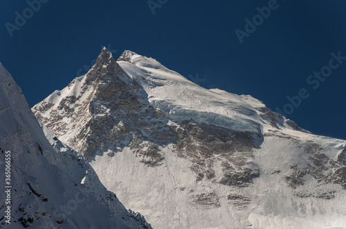 Manaslu summit rises above the far south end of Syancha glacier valley, as seen from Samdo village to Larkya Phedi camp on Manaslu Circuit trek, Manaslu Himal range, Gorkha district, Nepal Himalayas. photo