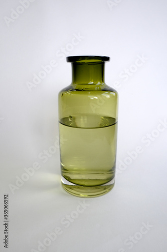 green vase bottle with liquid on a white background