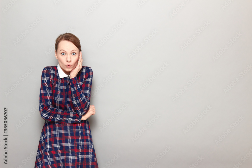 Portrait of shocked worried girl touching one cheek with hand Portrait of shocked worried girl touching one cheek with hand
