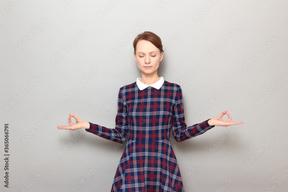 Portrait of young woman making breath exercises, trying to calm down Portrait of young woman making breath exercises, trying to calm down