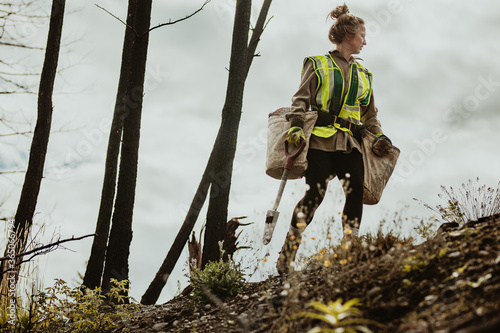 Female planting trees in forest