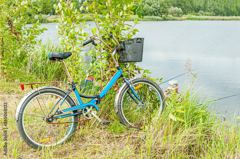 fisherman's bike in the grass near a lake