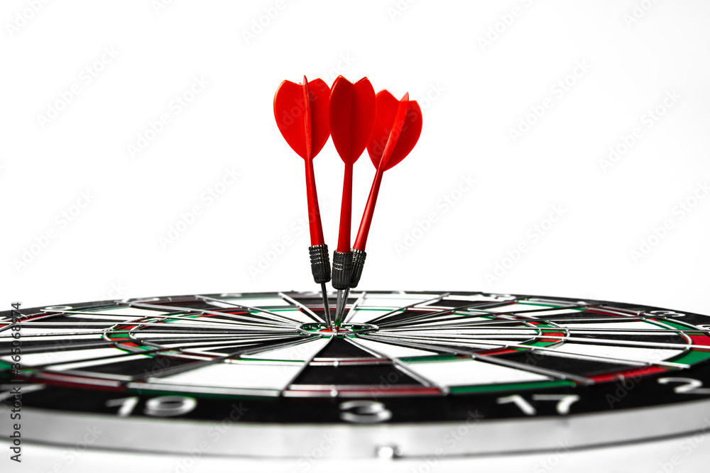 Fototapeta premium Close up shot red dart arrow on center of dartboard, metaphor to target success, winner concept, Isolated on white background with clipping path