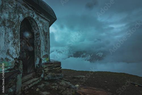 ruins of the mausoleum on the top of the mountain alps Austria just before heavy reain 