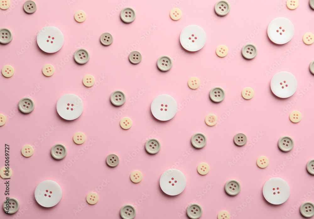 Different sewing buttons on pink background, flat lay Different sewing buttons on pink background, flat lay