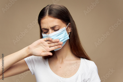 Pretty woman fashion clothes in a medical mask covid-19 epidemic 