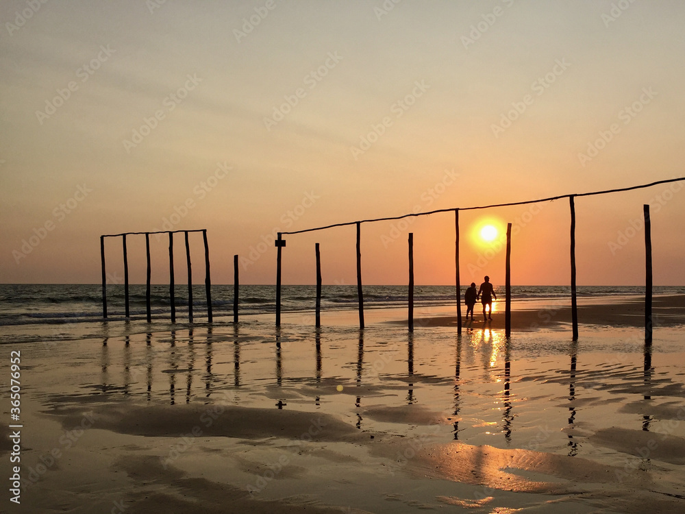 Beautiful seascape at sunset. Two silhouettes of sunset on the beach. Punta Umbria, Spain.