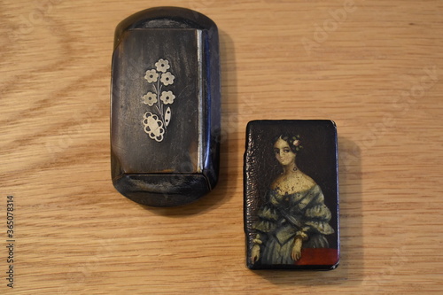 Ornate boxes produced in pocket size or larger communal for table use to keep the precious snuff dry. They hold amount of tobacco for immediate consumption and are intended to contain few days supply. photo