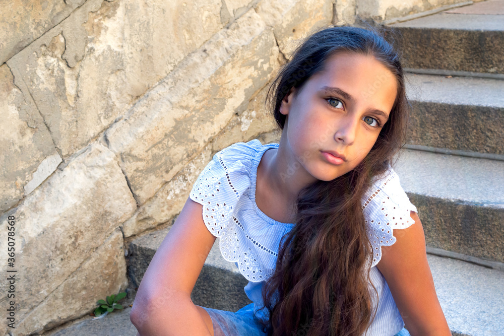 Portrait beautiful tanned caucasian girl against ancient stone wall. Attractive young tourist woman visiting city street old textured stone walls summer holiday, outdoors. Travel and lifestyle Portrait beautiful tanned caucasian girl against ancient stone wall. Attractive young tourist woman visiting city street old textured stone walls summer holiday, outdoors. Travel and lifestyle