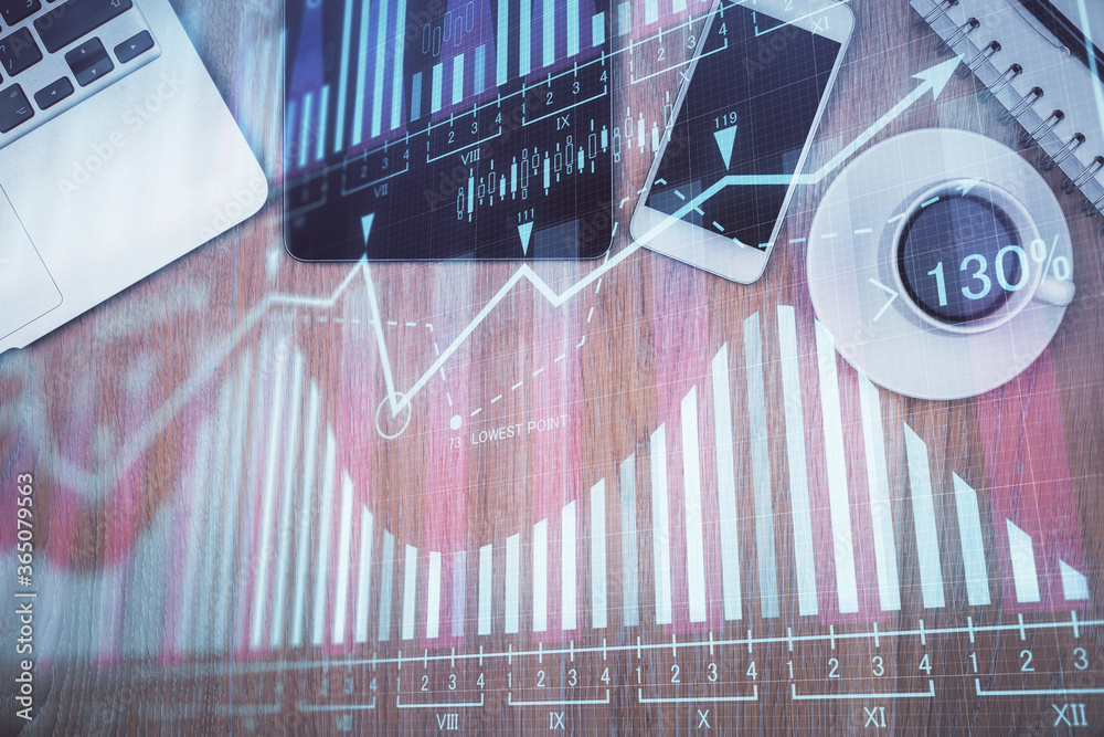 Double exposure of financial graph hologram over desktop with phone. Top view. Mobile trade platform concept. Double exposure of financial graph hologram over desktop with phone. Top view. Mobile trade platform concept.