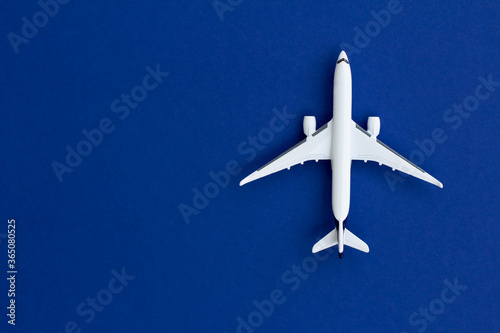 Model airplane. Insulated white toy plane. Travel concept. Flat lay. Place for your text