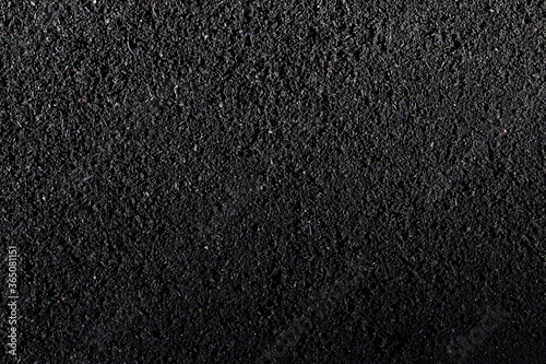 The texture of black rubberized asphalt. Rubber cover structure for running tracks and playgrounds.