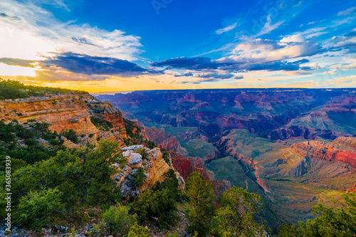 Panoramic image of the colorful Sunset on the Grand Canyon in Grand Canyon National Park from the south rim part Arizona USA  on a sunny cloudy day with blue or gloden sky