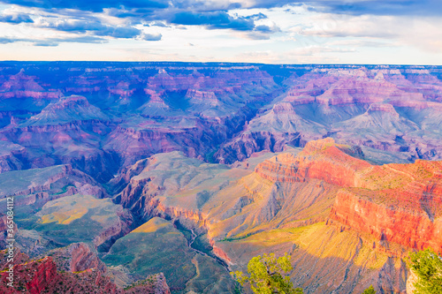 Panoramic image of the colorful Sunset on the Grand Canyon in Grand Canyon National Park from the south rim part,Arizona,USA, on a sunny cloudy day with blue or gloden sky © Daniel X D