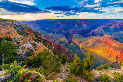 Panoramic image of the colorful Sunset on the Grand Canyon in Grand Canyon National Park from the south rim part,Arizona,USA, on a sunny cloudy day with blue or gloden sky © Daniel X D