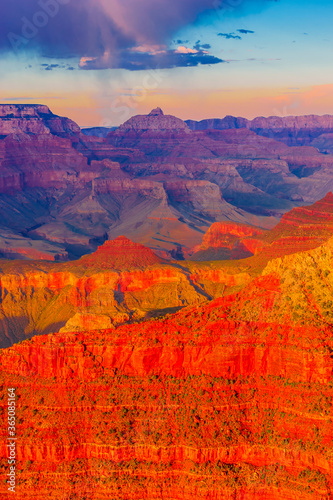 Panoramic image of the colorful Sunset on the Grand Canyon in Grand Canyon National Park from the south rim part Arizona USA  on a sunny cloudy day with blue or gloden sky
