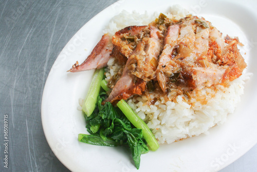 Crispy pork with rice on white dish
