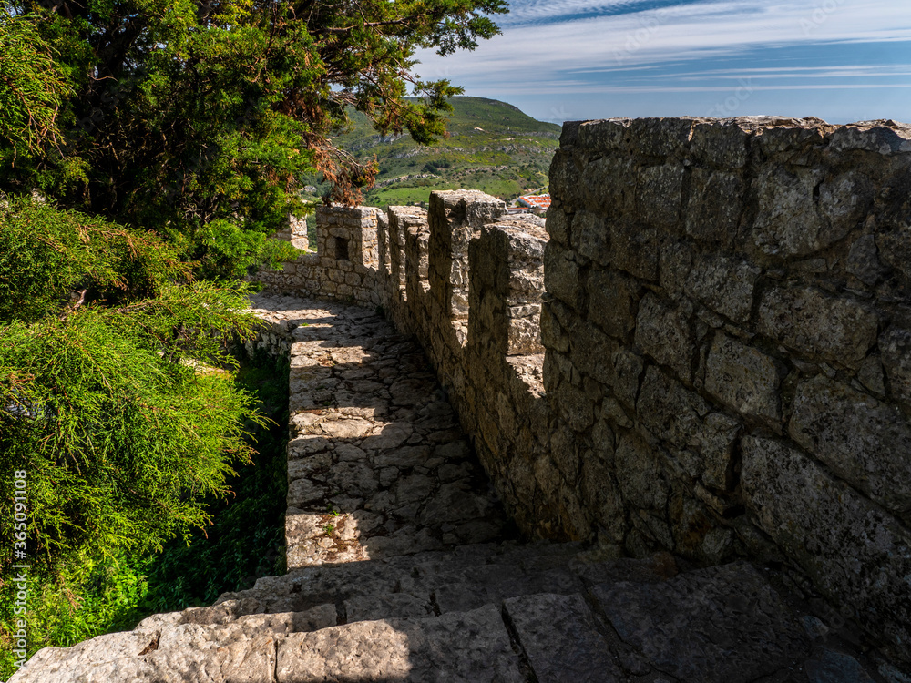 Medieval Castle Battlements. Ancient Moorish defensive wall in Portugal. Beautiful view of Sesimbra City.
