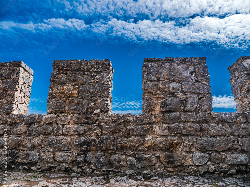 Sesimbra Medieval Castle Battlements. Ancient Moorish defensive wall in Portugal. Blue Cloudy Sky
