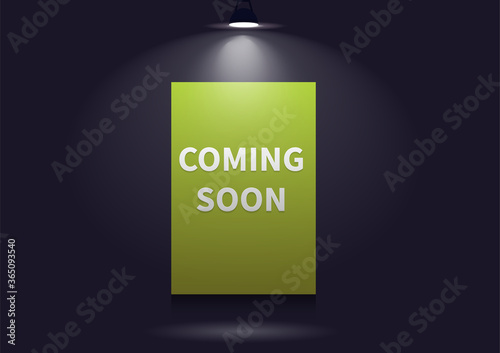 Coming soon message illuminated with light projector.