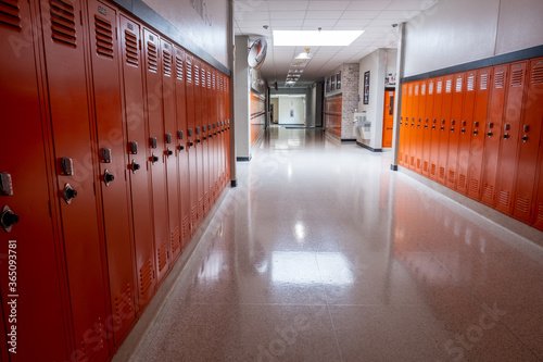 Фотография Empty hallway in school lined with orange lockers