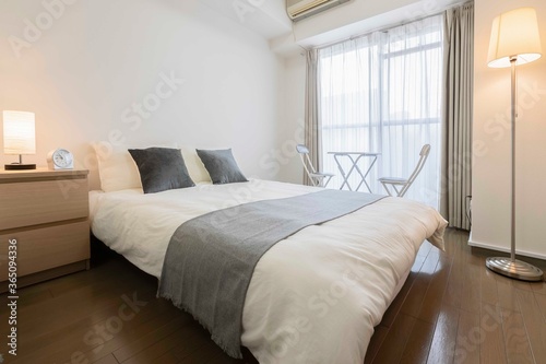 King size bed in modern small bedroom at apartment