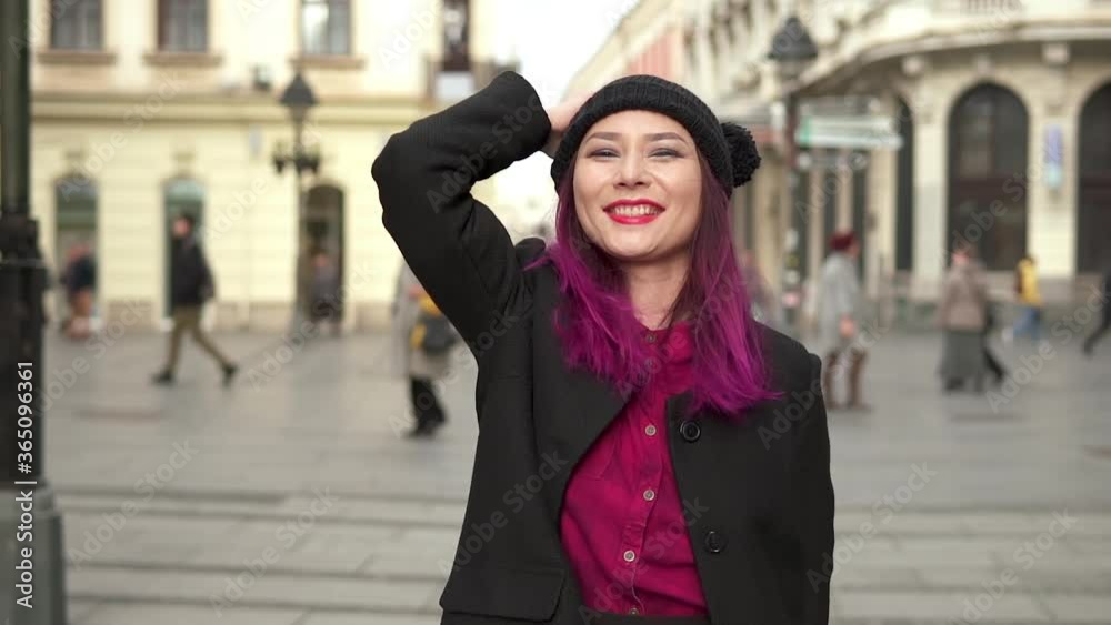 Portrait of elegant asian girl wearing stylish black coat, red shirt, and attractive black cap. Concept of vogue and hipster lifestyle. Attractive fashionable young woman walking in a beautiful street Portrait of elegant asian girl wearing stylish black coat, red shirt, and attractive black cap. Concept of vogue and hipster lifestyle. Attractive fashionable young woman walking in a beautiful street